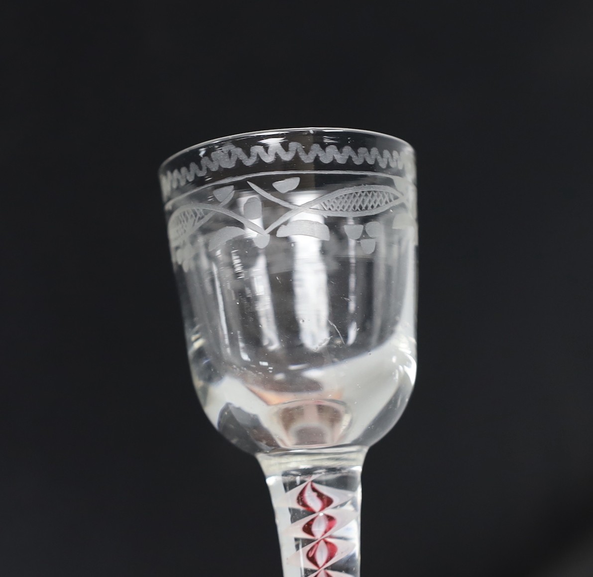 A Dutch red and white colour twist stem cordial glass, 13cms high